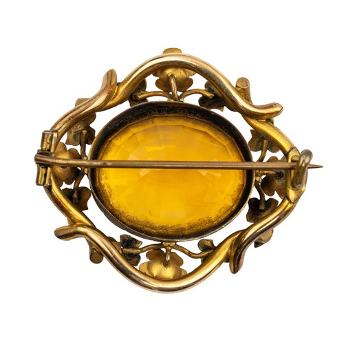 18 - A Victorian yellow metal split pearl and citrine paste broochThe oval-shaped stone wet within a pear... 
