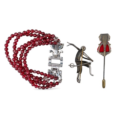 39 - A silver skier broochTogether with a faux coral and paste Buddha jabot pin and a red and white paste... 