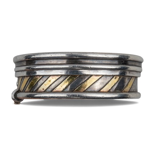 44 - Barbara BertagnolliA silver and gold multi gem-set stylised braceletDiameter: 69 mm.Total weight: Ap... 