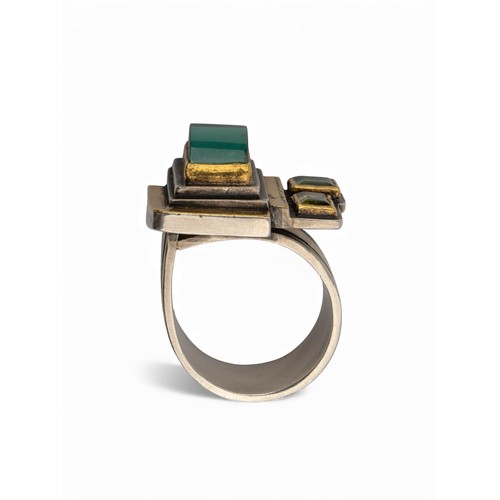 48 - Barbara BertagnolliA gold and silver gem-set dress ring. The abstract design set with a cabochon gre... 