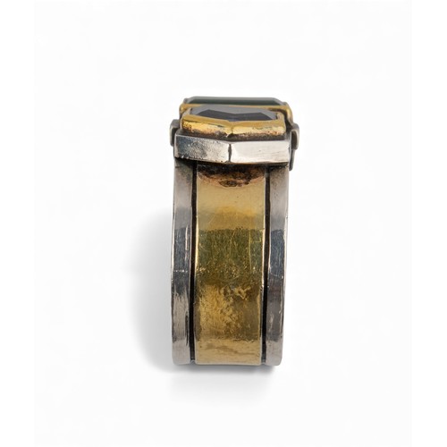50 - Barbara BertagnolliAn abstract silver gold and gem-set dress ring. Set with a rectangular-cut collet... 