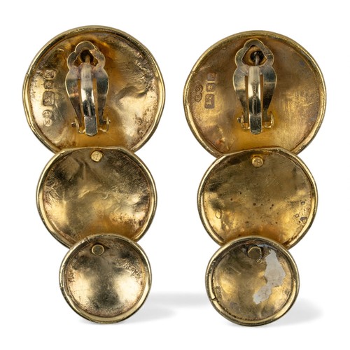 51 - Eileen CoyneA pair of silver gilt triple graduated disk earrings, with clip and peg fittingsSigned '... 
