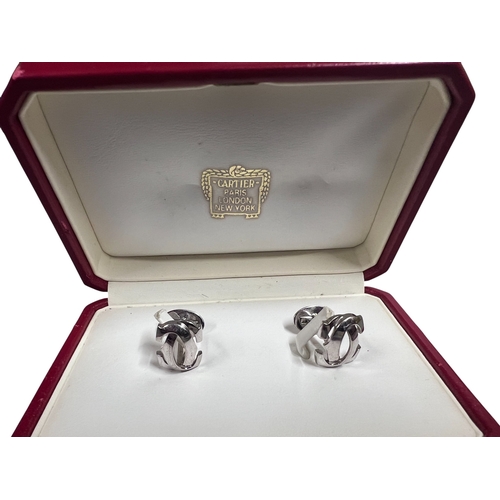 21A - CartierA pair of 18 carat white gold C de Cartier cufflinksIn original Cartier box, with certificate... 