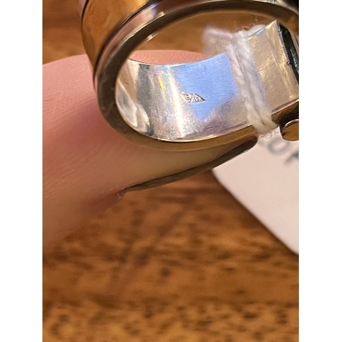50 - Barbara BertagnolliAn abstract silver gold and gem-set dress ring. Set with a rectangular-cut collet... 