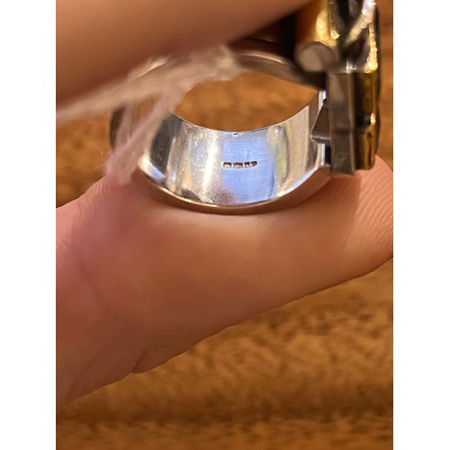 50 - Barbara BertagnolliAn abstract silver gold and gem-set dress ring. Set with a rectangular-cut collet... 