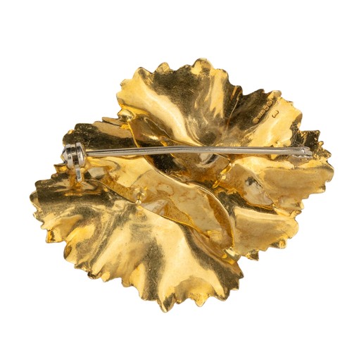 27 - A gold and ruby-set brooch, circa 1970Designed as a flower, the centre set with four small brilliant... 
