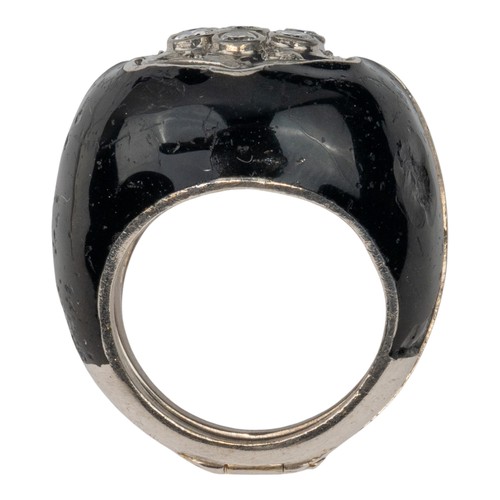 40 - An unusual diamond-set dress ring, circa 1960/70Encased in a black enamel and silver metal outer fra... 