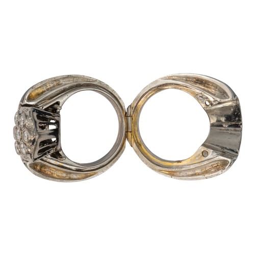 40 - An unusual diamond-set dress ring, circa 1960/70Encased in a black enamel and silver metal outer fra... 