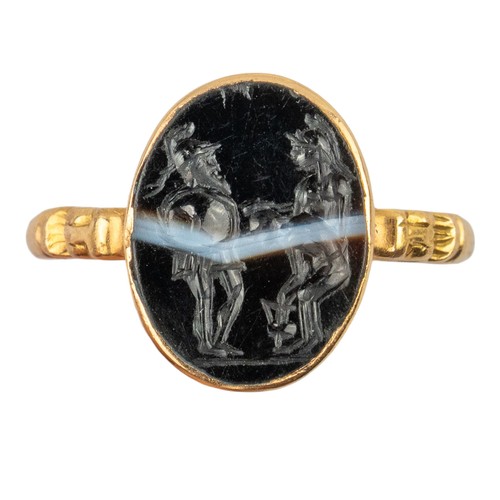 62 - Roman, 1st-2nd century BCA banded agate intaglio depicting the sons of ZeusSet in a later gold mount... 