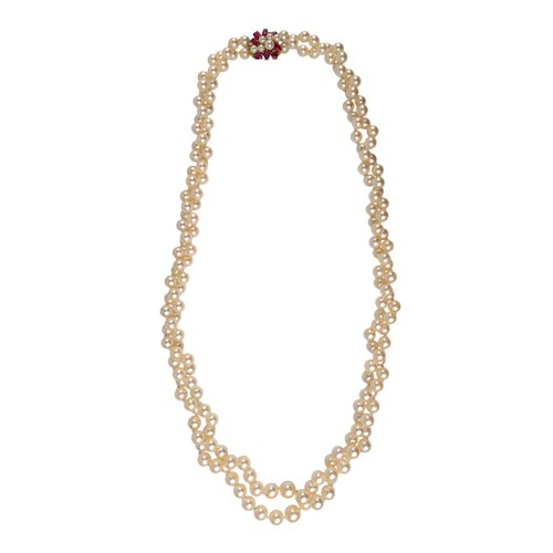 63 - A two-row graduated cultured pearl necklace, with a ruby and pearl clasp, circa 1960The two-row grad... 