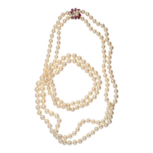 63 - A two-row graduated cultured pearl necklace, with a ruby and pearl clasp, circa 1960The two-row grad... 
