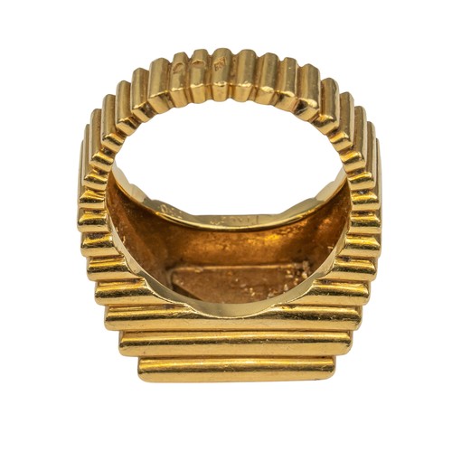 69 - Piaget, 1970sAn 18k gold, diamond and malachite gentleman's dress ring. The heavy yellow gold ribbed... 