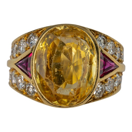74 - A yellow sapphire, ruby and diamond dress ring, circa 1980The oval-shaped mixed-cut yellow sapphire ... 