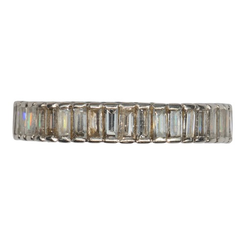 102 - A good quality baguette diamond and platinum full eternity ring, circa 1970The band channel-set with... 