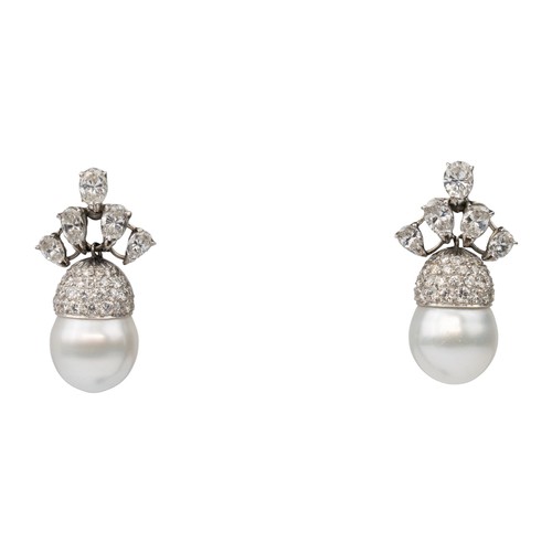 105 - A pair of diamond and South Sea cultured pearl pendant earrings, circa 1970The scroll top set with f... 