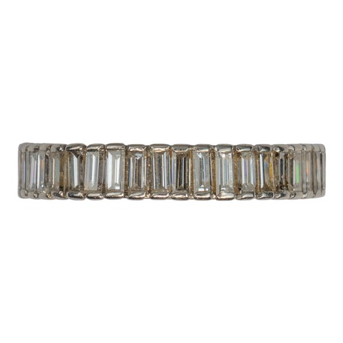 102 - A good quality baguette diamond and platinum full eternity ring, circa 1970The band channel-set with... 