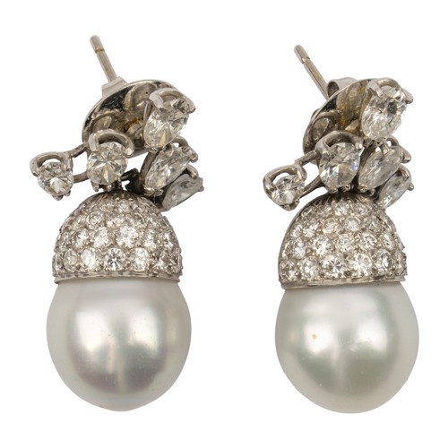 105 - A pair of diamond and South Sea cultured pearl pendant earrings, circa 1970The scroll top set with f... 