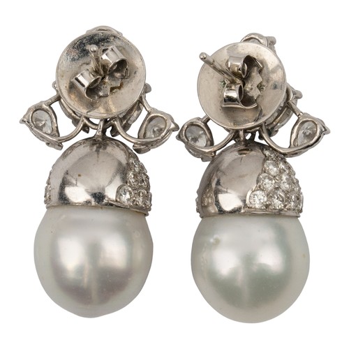 105 - A pair of diamond and South Sea cultured pearl pendant earrings, circa 1970The scroll top set with f... 
