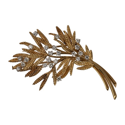 101 - Cartier, ParisAn attractive diamond and 18k gold spray brooch, circa 1950With fern-type leaves and s... 