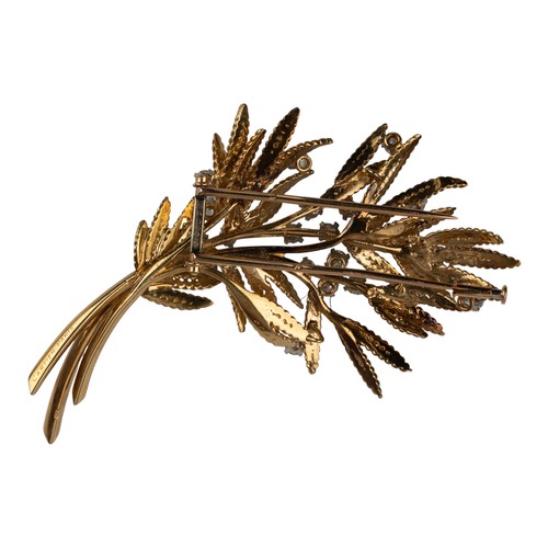 101 - Cartier, ParisAn attractive diamond and 18k gold spray brooch, circa 1950With fern-type leaves and s... 
