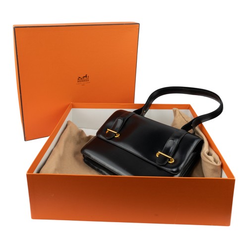 144 - Herm&egrave;s, A black calf leather Dolly shoulder bagThe box-shaped bag with two leather fastening ... 