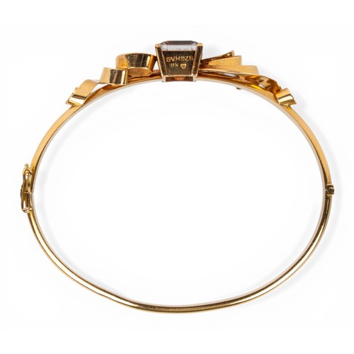 4 - Danish, circa 1970sAn 18ct gold and crystal bangleSet to the top with a rectangular emerald-cut rock... 