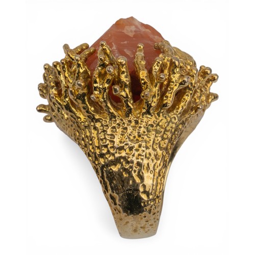 21 - A yellow metal and crystal-set dress ring, circa 1960sThe natural orange-coloured agate crystal set ... 