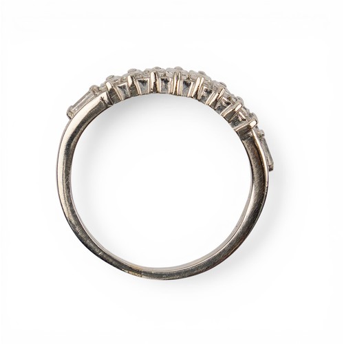 16 - A baguette diamond dress ringThe half hoop set to the centre with eight baguette-cut diamonds, and w... 