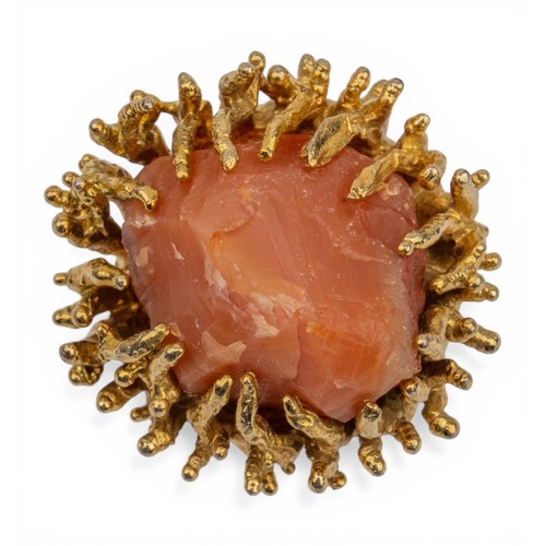 21 - A yellow metal and crystal-set dress ring, circa 1960sThe natural orange-coloured agate crystal set ... 