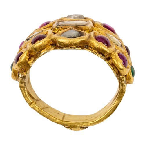 31 - IndianLate 19th CenturyA high carat gold gem set ringThe wide band set with cabochon rubies, emerald... 