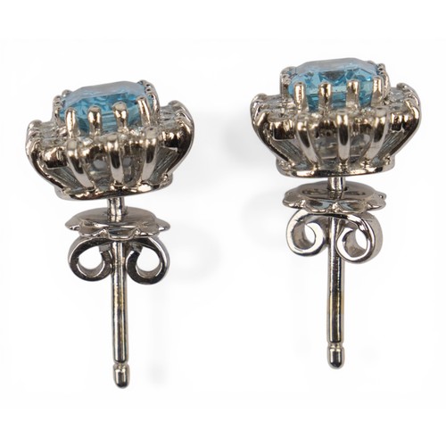 38 - A pretty pair of aquamarine and diamond cluster earringsEach rectangular-cut aquamarine of pretty co... 