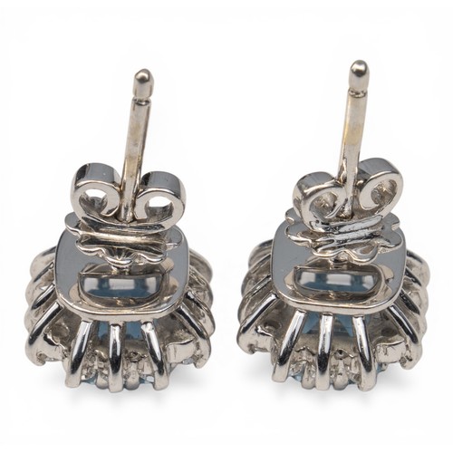 38 - A pretty pair of aquamarine and diamond cluster earringsEach rectangular-cut aquamarine of pretty co... 