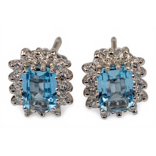 38 - A pretty pair of aquamarine and diamond cluster earringsEach rectangular-cut aquamarine of pretty co... 