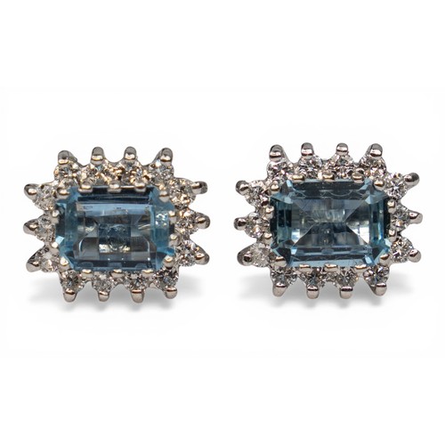 38 - A pretty pair of aquamarine and diamond cluster earringsEach rectangular-cut aquamarine of pretty co... 