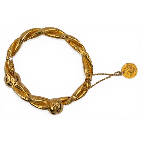 34 - Eastern, AntiqueA high-carat gold hollow bangle, of entwined torque design, with ball terminals.Inte... 