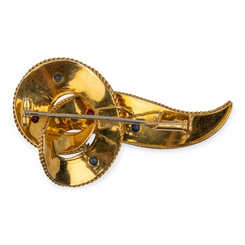 33 - A gold and gem-set brooch, circa 1940sDesigned as a bright-cut fluted gold scroll, with wirework bor... 