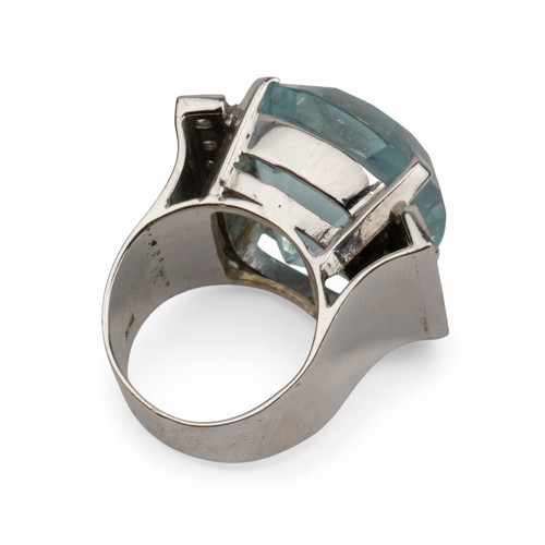 43 - An impressive aquamarine and diamond dress ring, circa 1970The central cushion-shaped aquamarine of ... 