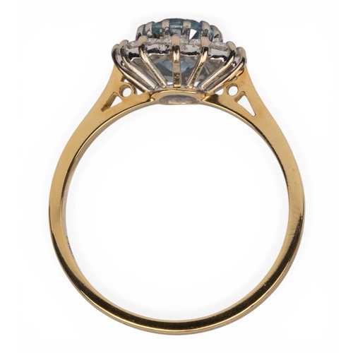 41 - An aquamarine and diamond cluster ring, circa 1980sThe oval-shaped mixed-cut aquamarine of pretty co... 
