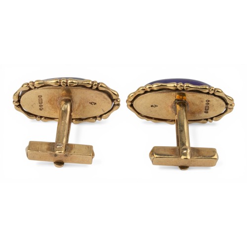 52 - 1970s, A striking pair of cabochon amethyst and 9ct gold cufflinksThe large oval cabochon amethysts ... 
