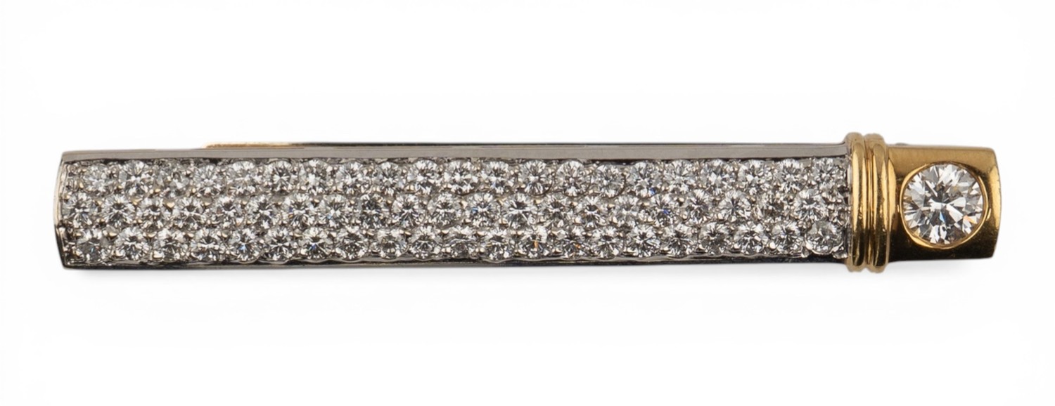 An 18ct white and yellow gold diamond-set tie clipThe front pave-set ...