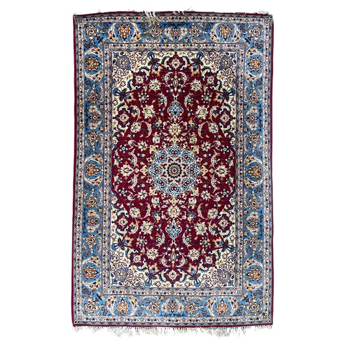 An Isfahan rug A deep raspberry field with palmettes and strolling ...