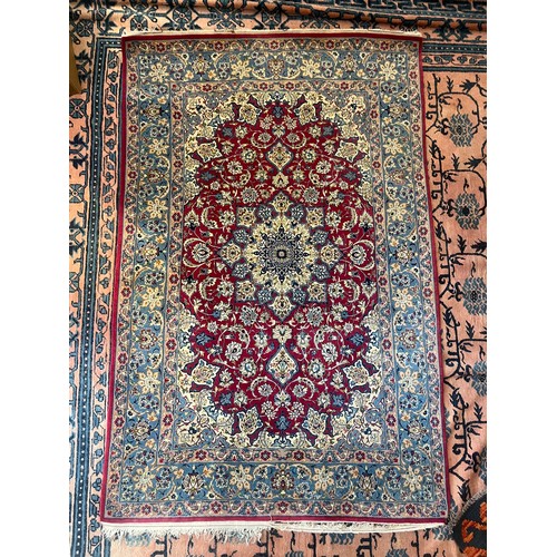 An Isfahan rug A deep raspberry field with palmettes and strolling ...
