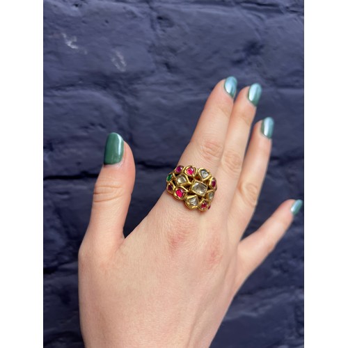 31 - IndianLate 19th CenturyA high carat gold gem set ringThe wide band set with cabochon rubies, emerald... 