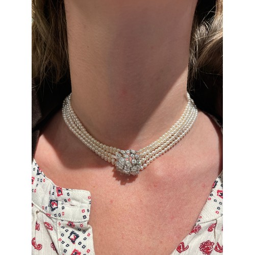 56 - A diamond and six-row cultured pearl choker necklaceThe cluster clasp set with pear-shaped marquise ... 
