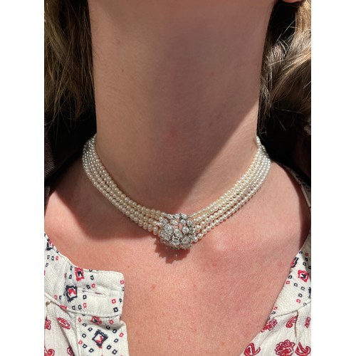 56 - A diamond and six-row cultured pearl choker necklaceThe cluster clasp set with pear-shaped marquise ... 