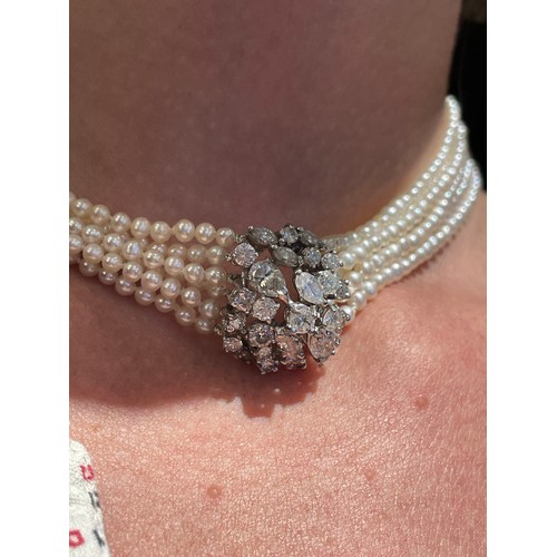 56 - A diamond and six-row cultured pearl choker necklaceThe cluster clasp set with pear-shaped marquise ... 