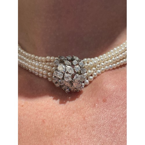 56 - A diamond and six-row cultured pearl choker necklaceThe cluster clasp set with pear-shaped marquise ... 