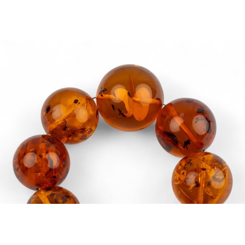 4 - A fine Baltic amber bead necklaceComposed of twenty-three graduated 34 mm. to 22 mm. amber beads.Tot... 