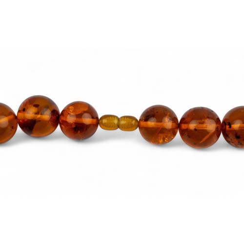 4 - A fine Baltic amber bead necklaceComposed of twenty-three graduated 34 mm. to 22 mm. amber beads.Tot... 