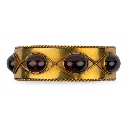 7 - Antique, An impressive cabochon garnet and gold bangle, circa 1870The Etruscan-style bloomed gold wi... 